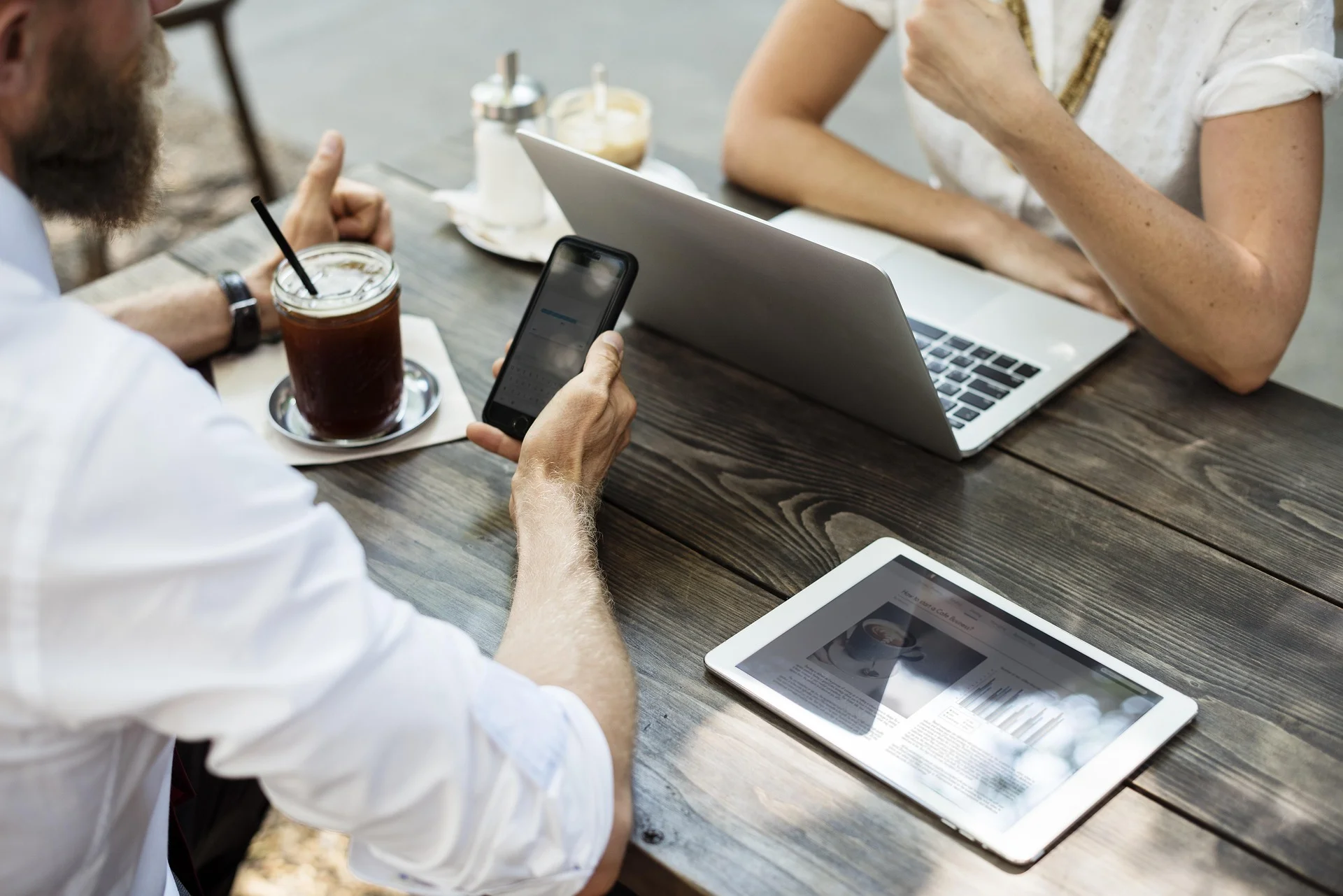 broker speaking with client at desk with laptop