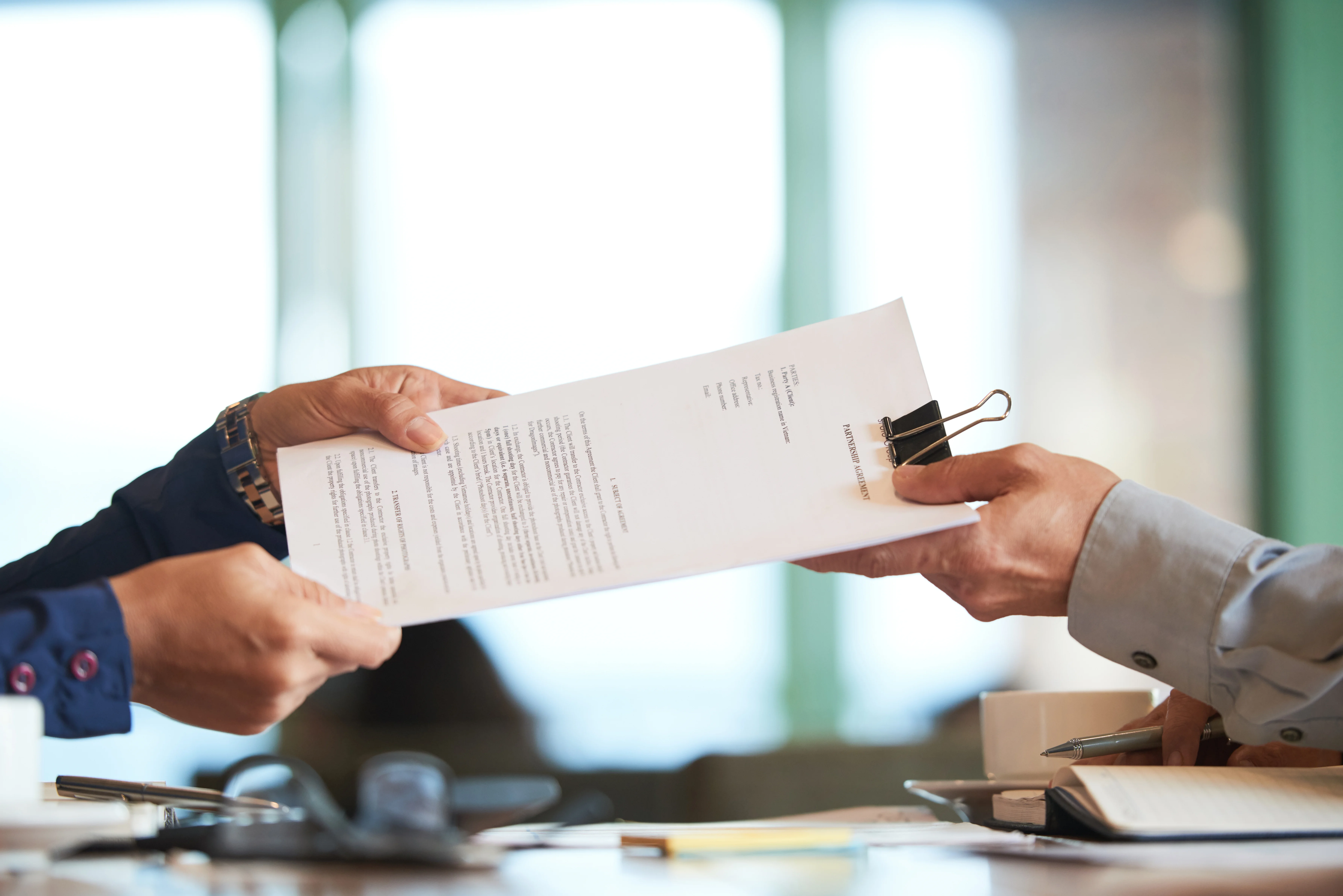 close up of doctor handing medical bill to patient with no catastrophic heath insurance plan