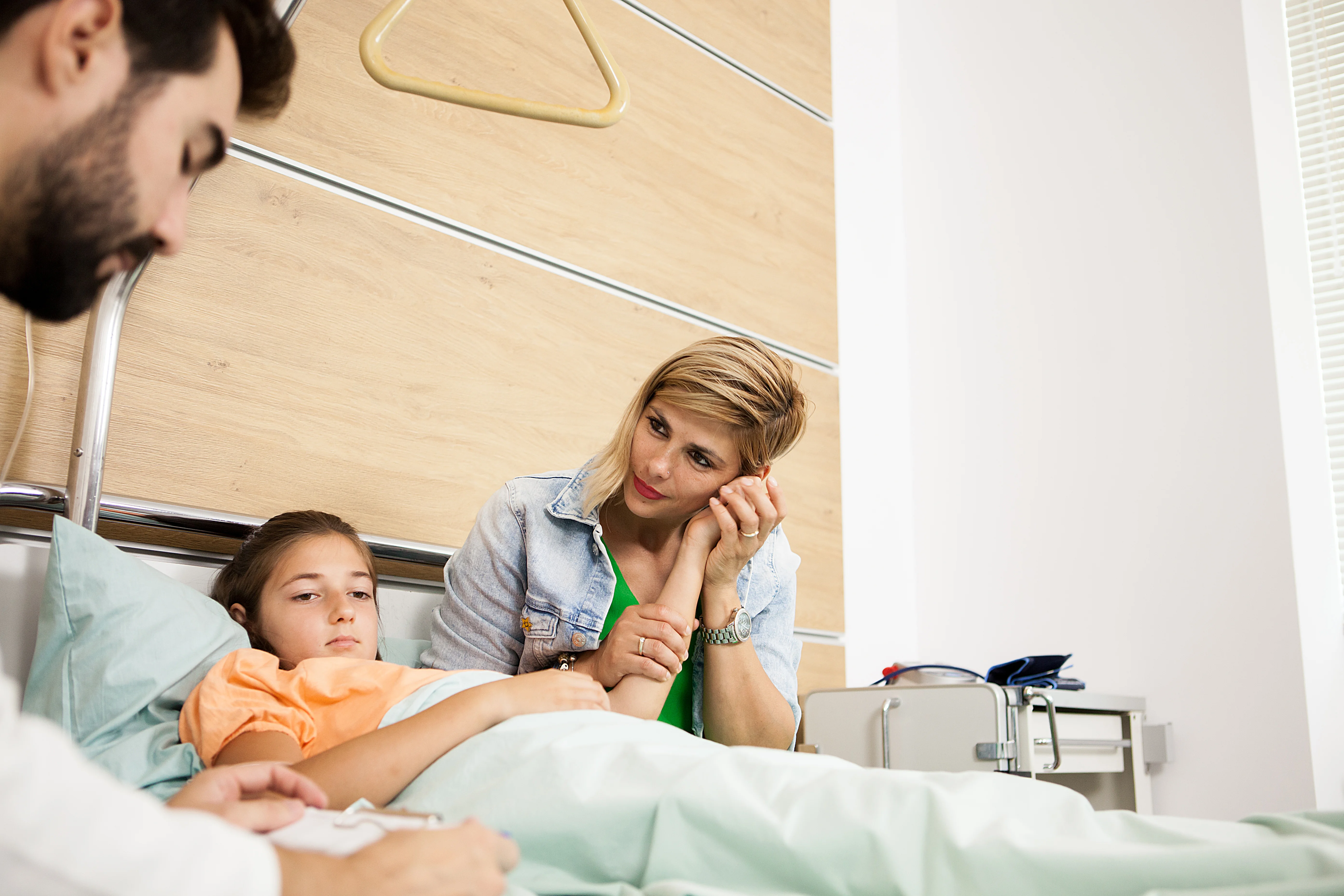 close up of parents in hospital with sick child