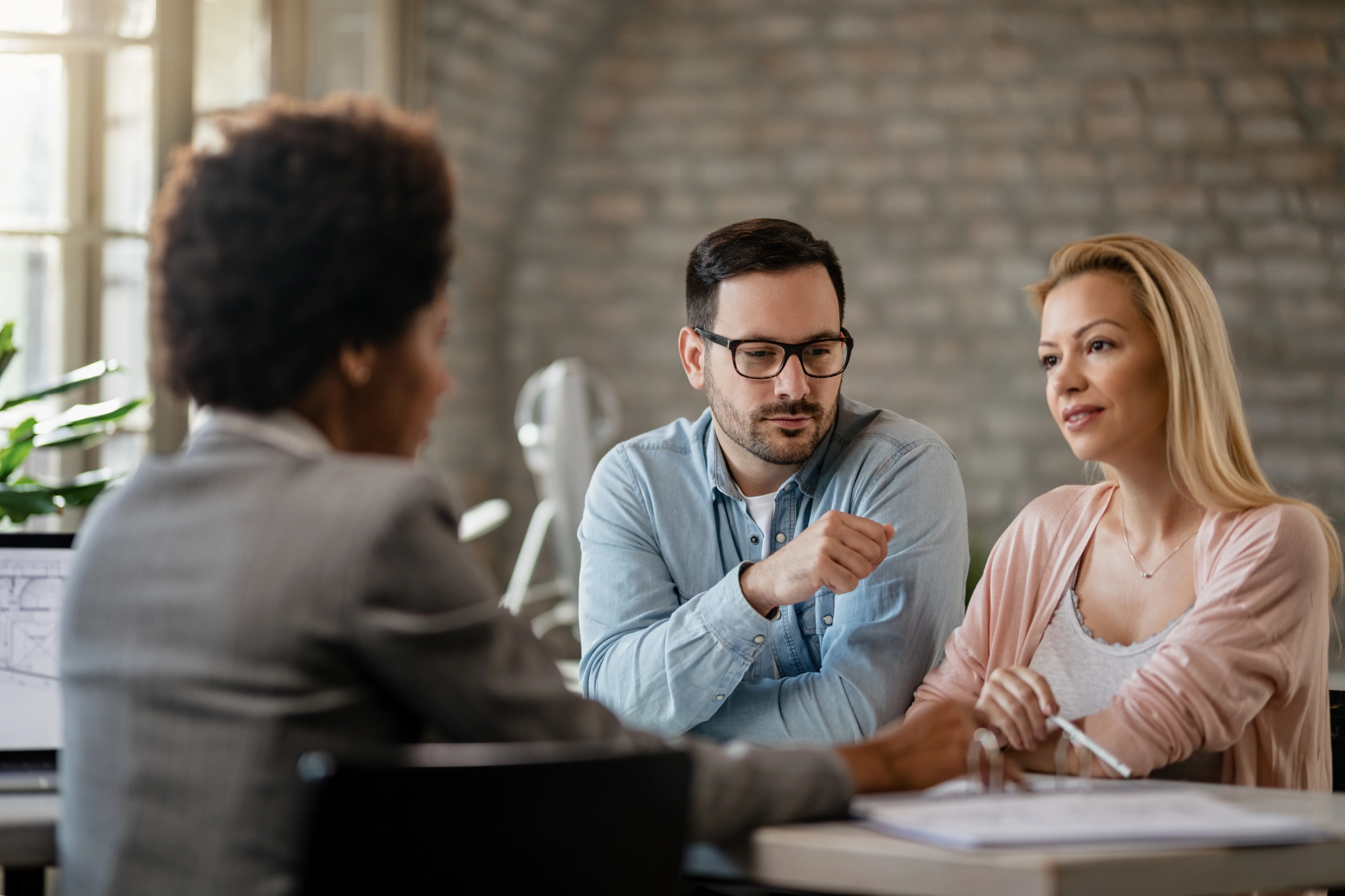 coworkers discussing options with insurance advisor after losing job