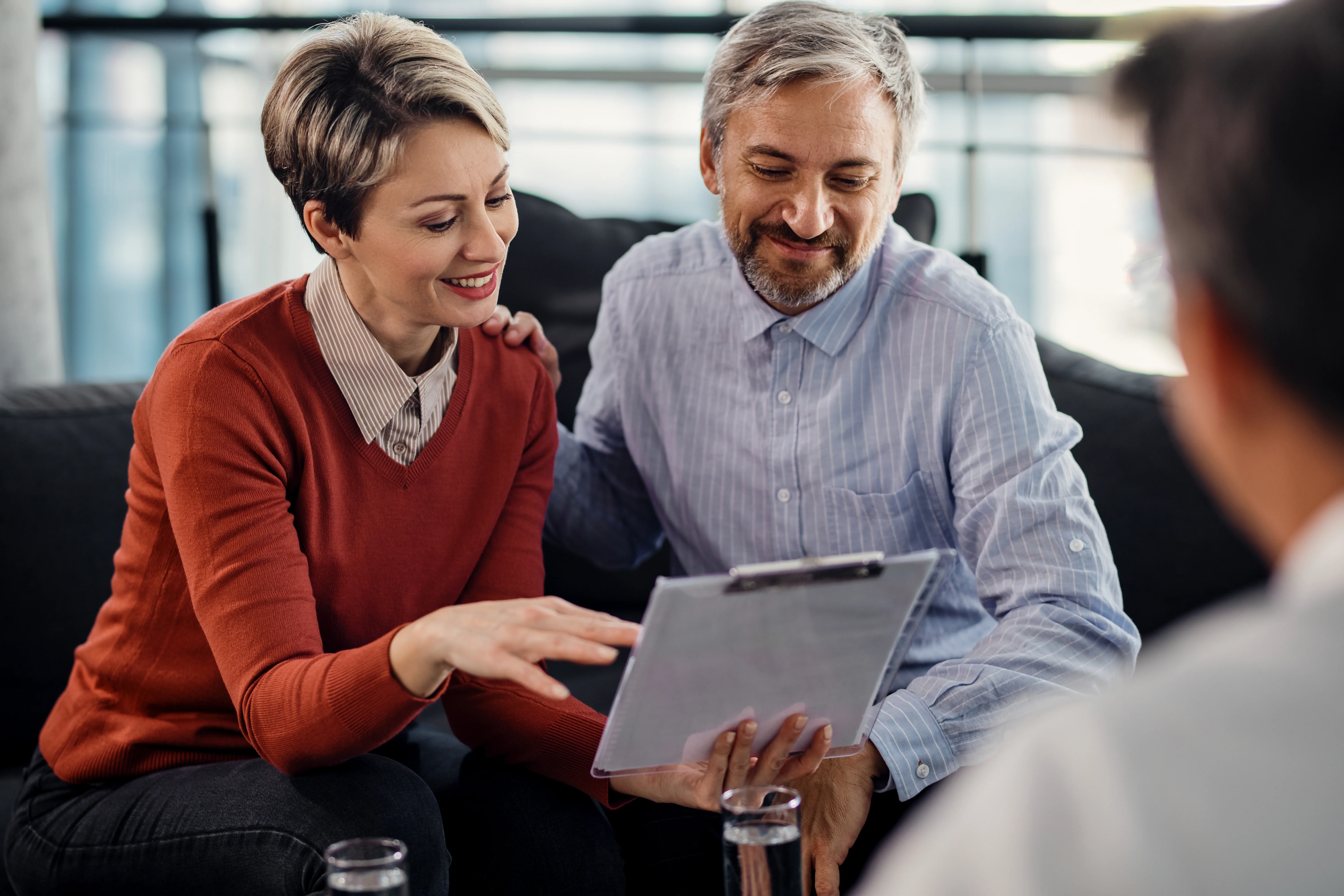 Happy couple reviewing insurance plan for domestic partner health insurance
