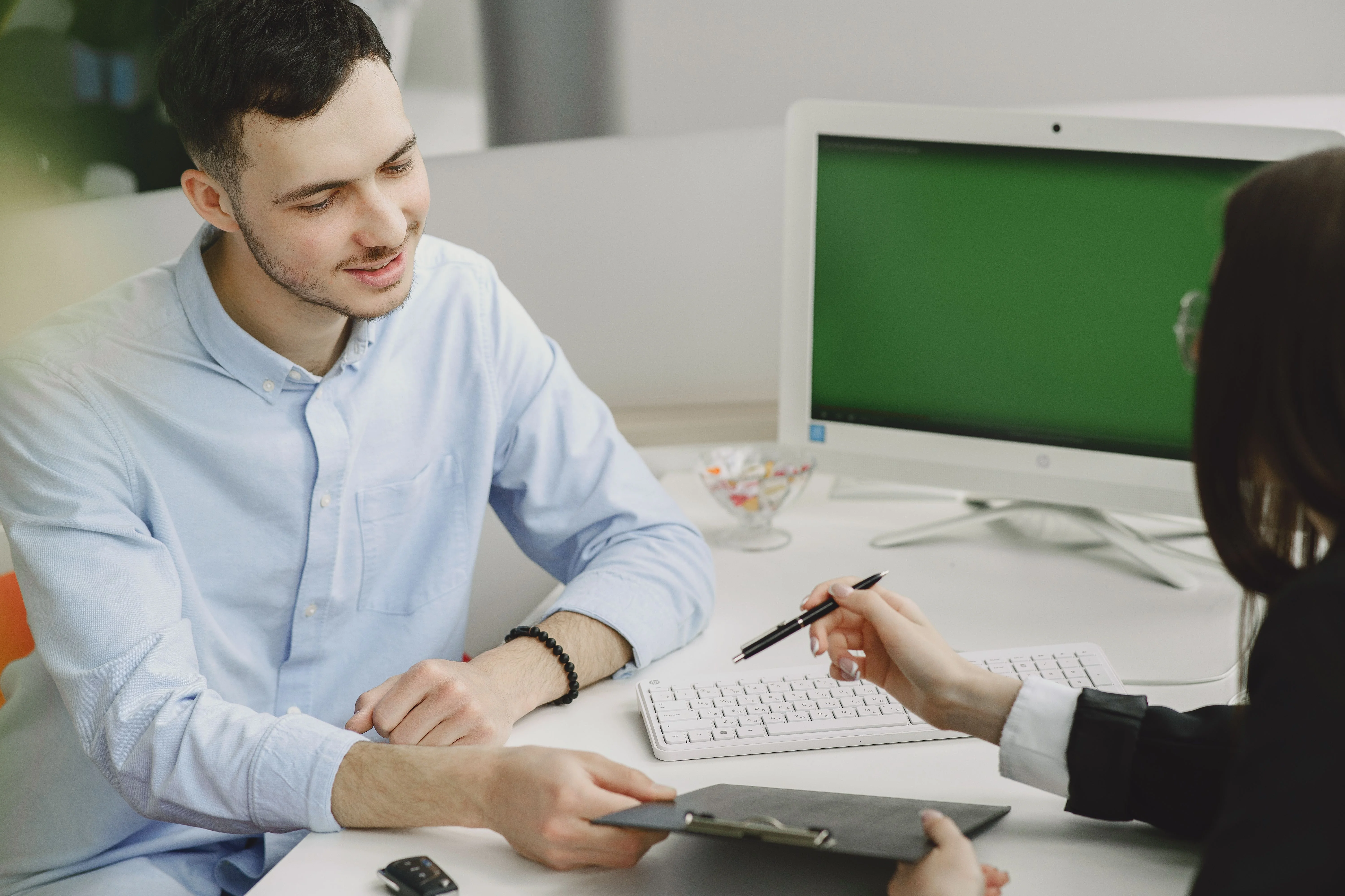 Insurance advisor discussing private health insurance options and coverage details with a client