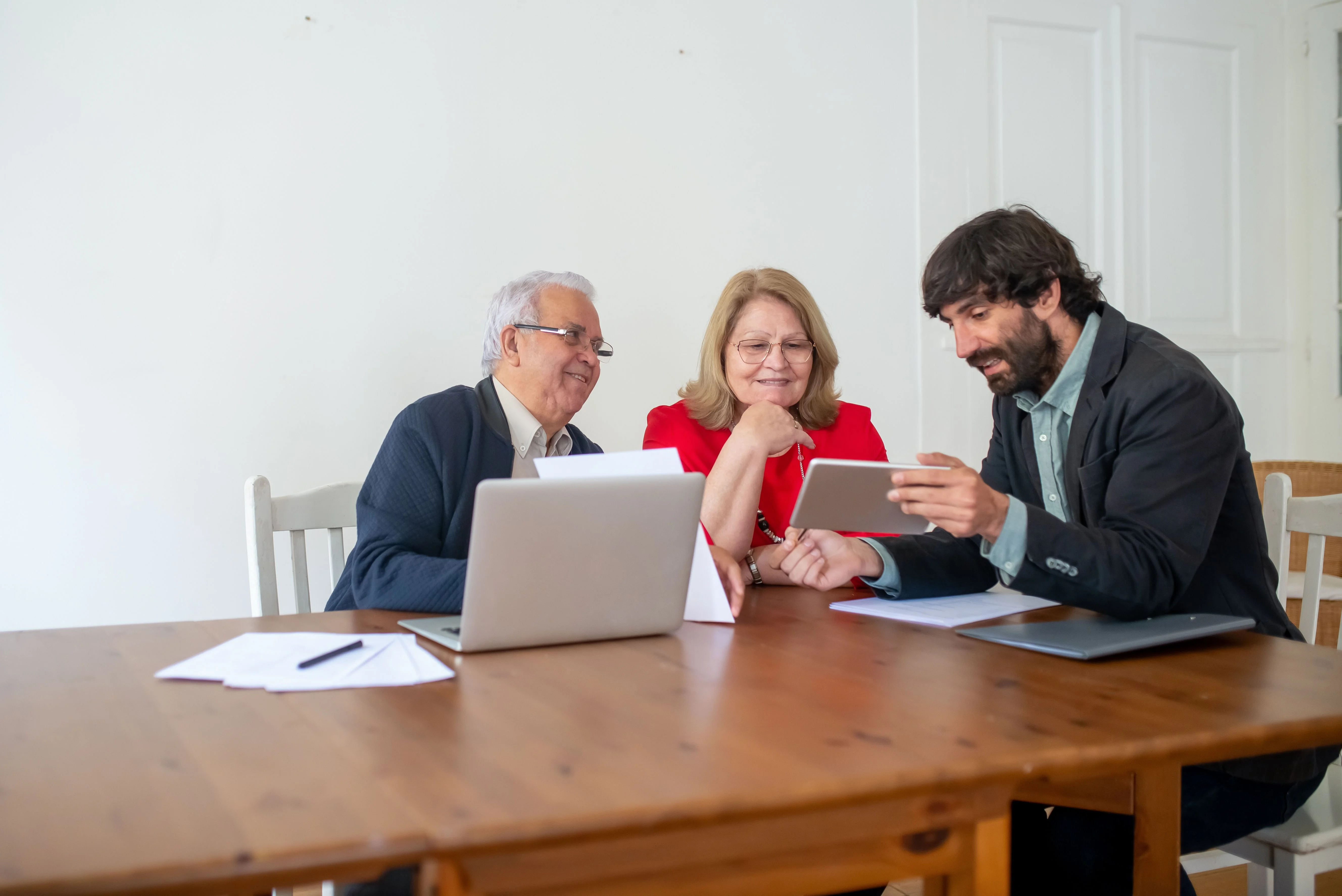 Man explaining to clients what they can deduct from their insurance