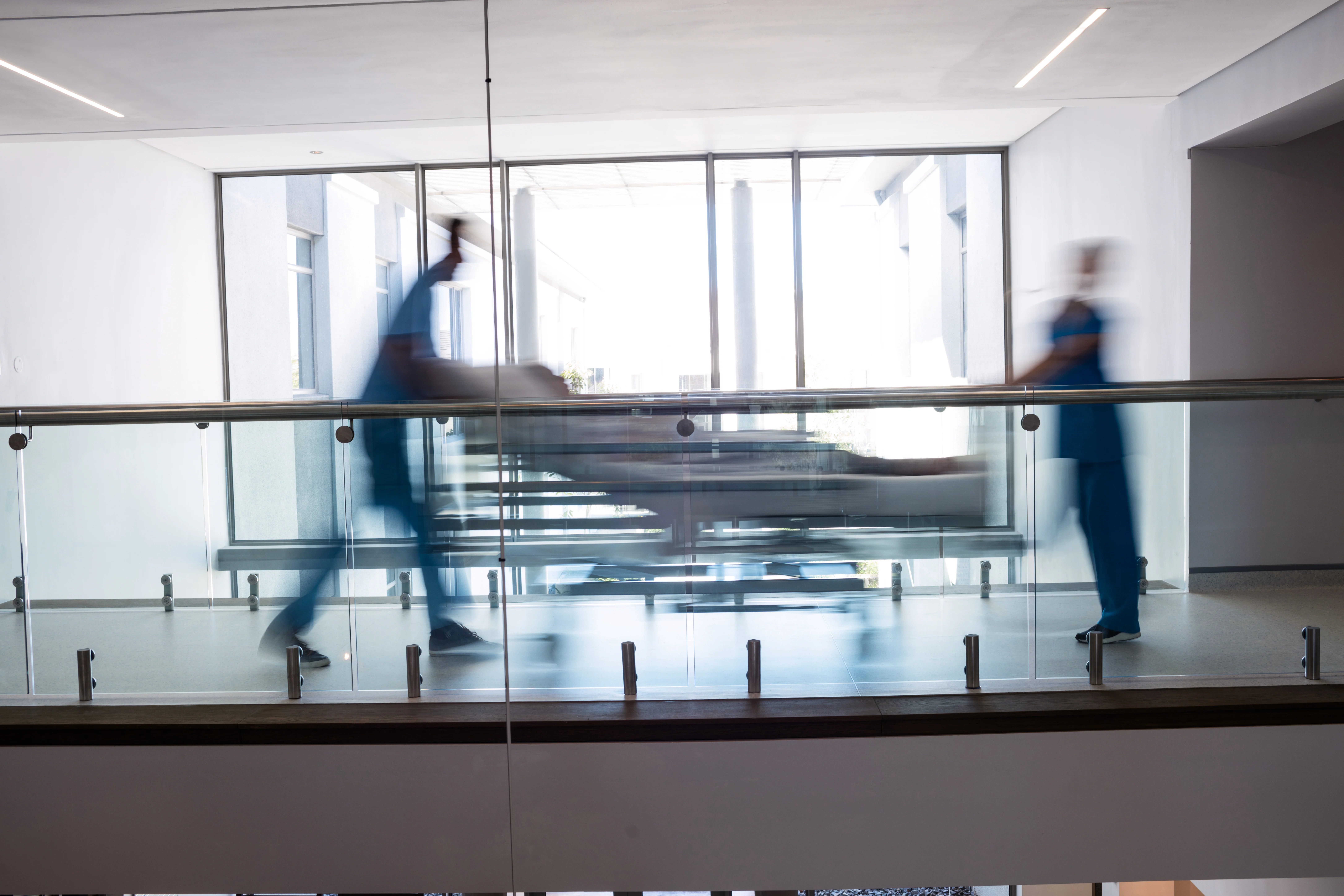 nurses rushing patient to emergency room in hospital
