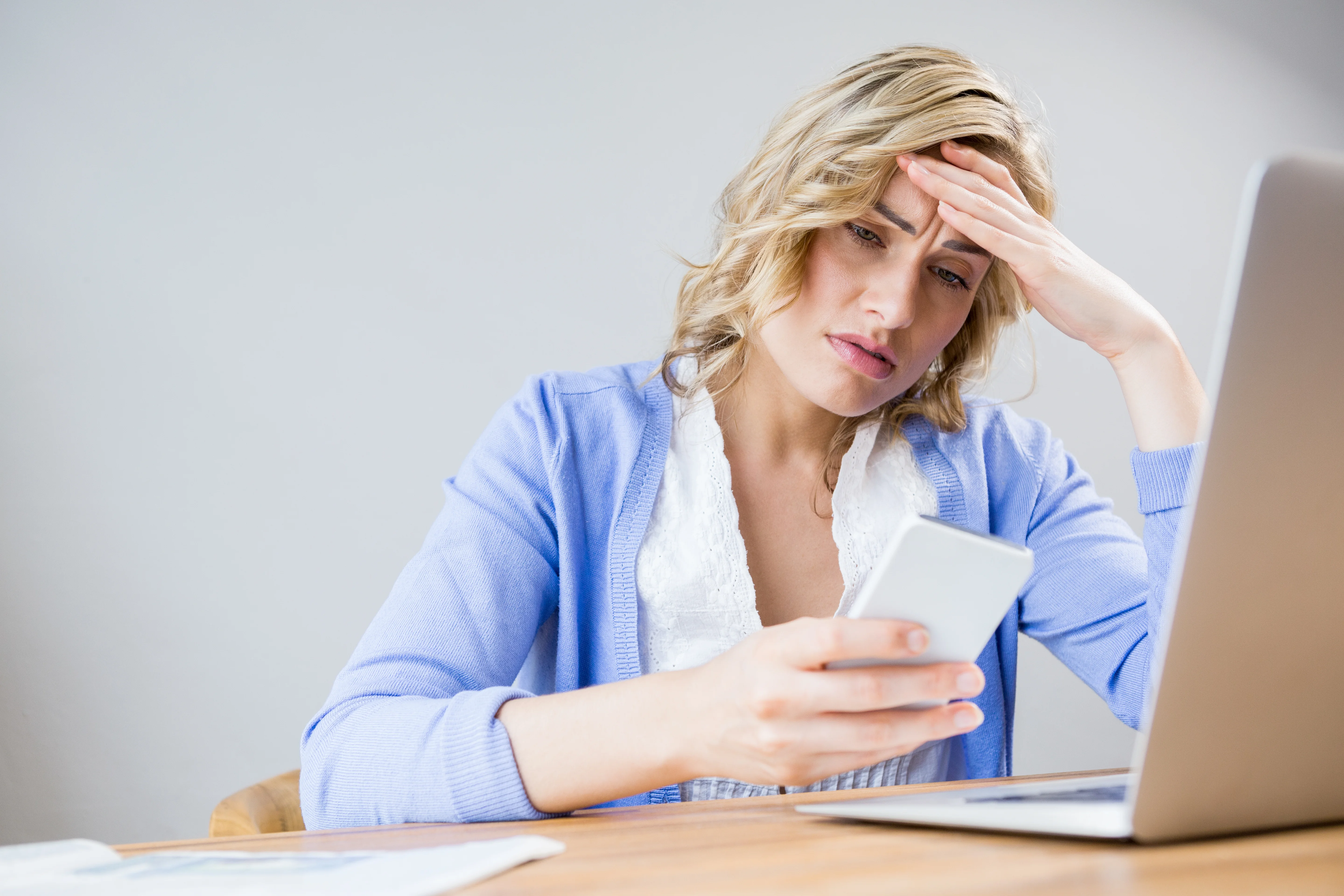 Small business owner on phone with insurance provider