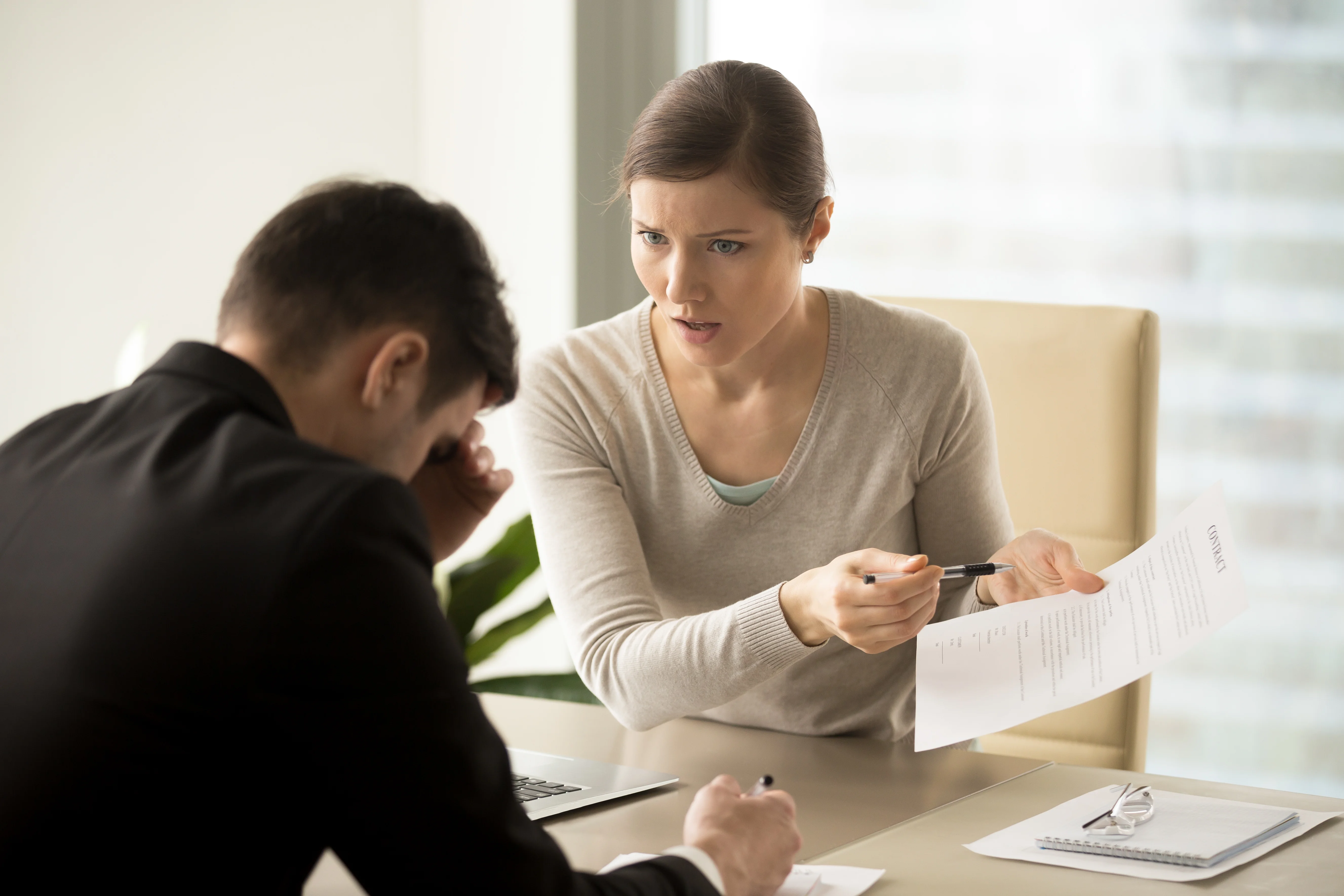 Women speaking with man explaining insurance coverage forms to client